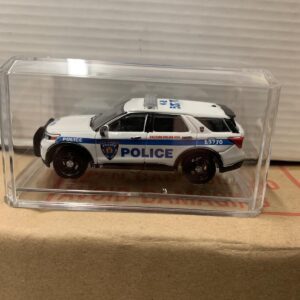 A miniature police SUV model in a clear display case.