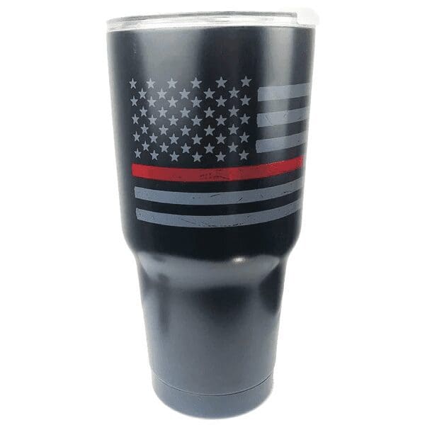 A black tumbler with a faded American flag and a red line.